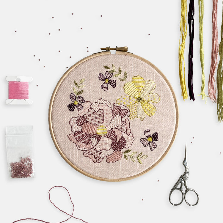Floral Embroidery Kits - Kirsty Freeman Design. Create a pretty embroidery design from our range of kits, this pink floral embroidery kit combines shades of pink alongside yellow and purple flowers and olive green leaves.