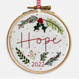 Christmas Decoration Kits - Kirsty Freeman Design. The hope embroidery kit includes gold and red seed beads, fir tree leaves, holly, berries and mistletoe, alongside the option of the year 2022.