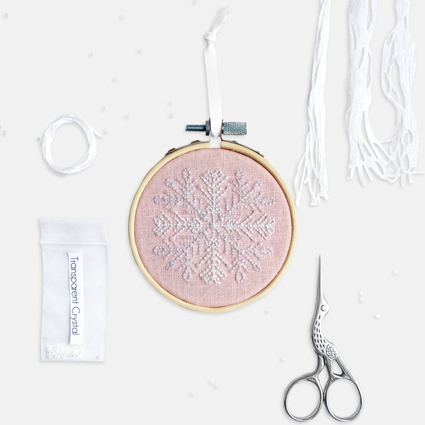 Snowflake Embroidery Kit - Kirsty Freeman Design. An embroidered Christmas decoration, stitched onto pink linen fabric, created using backstitch.