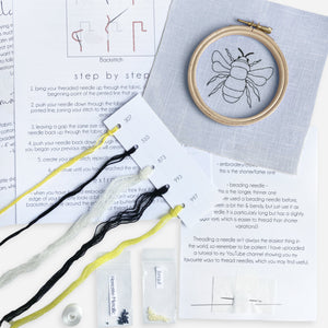 Bee Embroidery Kit Designed and Made in the UK - Kirsty Freeman Design. Contents of the embroidery kit include needles, linen fabric with stitched outline, instructions, threads, beads and an embroidery hoop.