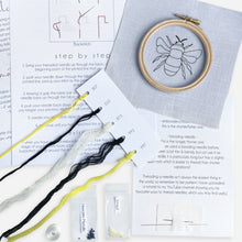 Load image into Gallery viewer, Bumble Bee Embroidery Kit - Kirsty Freeman Design. Contents of the blue bumble bee embroidery kit, including instructions, embroidery hoop, fabric, beads and threads.
