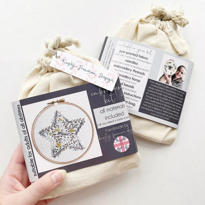 Front of Christmas Star Embroidery Kit packaging showing botanical hand embroidery design with star motif inside a cotton bag.