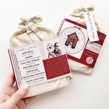 Back of Gingerbread House Cross Stitch Kit packaging listing cross stitch materials included.