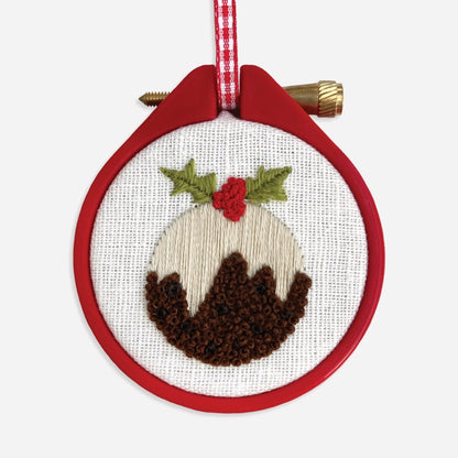Close-up of stitched Christmas pudding embroidery using satin stitch and French knots.