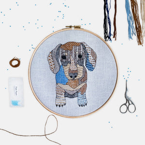 Sausage Dog Embroidery Kit - Kirsty Freeman Design. A dachshund stitched onto blue linen fabric, using patterned embroidery stitches and seed beads.