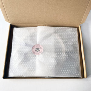 Bee Embroidery Kit - Kirsty Freeman Design. Everything needed to complete the embroidery kit is packed inside tissue paper, sealed with a branded sticker and packed inside a cardboard box.