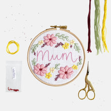 Load image into Gallery viewer, Mum Embroidery Kit - Kirsty Freeman Design. Make your own embroidery for a mother figure, we have added the name &#39;mum&#39; to the centre of this design, surrounded by pink and yellow flowers, green leaves and burgundy berries.
