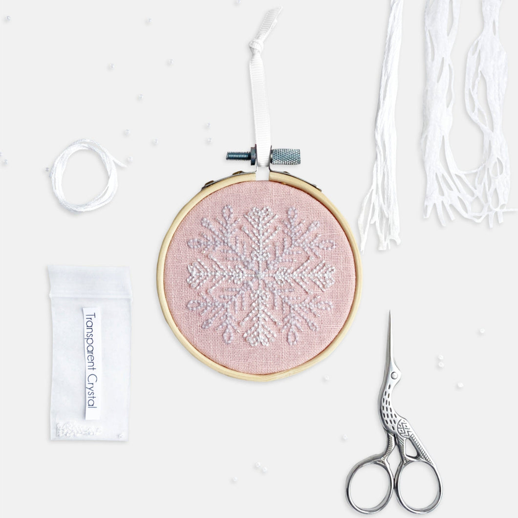 Snowflake Embroidery Kit - Kirsty Freeman Design. An embroidered Christmas decoration, stitched onto pink linen fabric, created using backstitch.