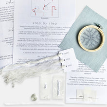 Load image into Gallery viewer, Christmas Snowflake Embroidery Kit - Kirsty Freeman Design. The contents of the blue snowflake embroidery kit includes: linen fabric, embroidery hoop, needles, beads, threads and instructions.
