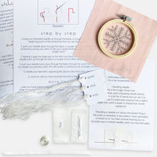 Load image into Gallery viewer, Snowflake Embroidery Kit - Kirsty Freeman Design.  The contents of the embroidery kit include: instructions, pre-printed fabric, embroidery hoop, needles, threads, beads and ribbon.
