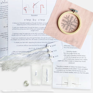 Snowflake Embroidery Kit - Kirsty Freeman Design.  The contents of the embroidery kit include: instructions, pre-printed fabric, embroidery hoop, needles, threads, beads and ribbon.