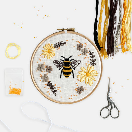 Bee Embroidery Kit - Kirsty Freeman Design. Sit down and relax with our calming embroidery kit, creating using threads in shades of orange, yellow and grey. A premium selection of threads, beads and fabric are supplied to help you create your own beautiful embroidery.